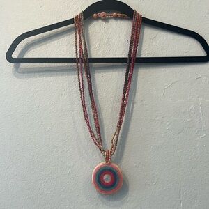 Rainbow beaded necklace with coiled rope pendant